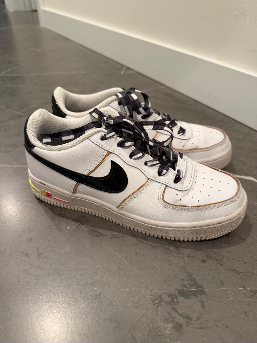 Nike White Sneakers with Black Swoosh and Yellow Accents